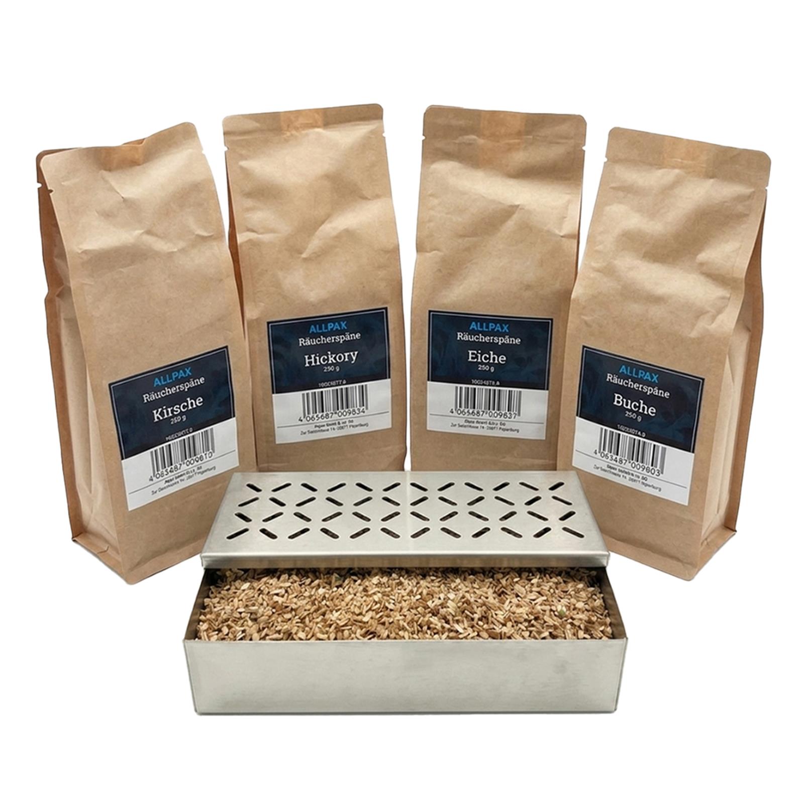 ALLPAX Räucherbox Smokerbox befüllt mit Räucherspänen, im Hintergrund Räucherspänepackungen Buche, Eiche, Kirsche und Hickory
